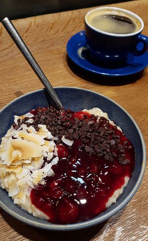 Haferkater's vegan "Waldbeerkater" with German forest berry sauce, roasted coconut flakes and dark chocolate chips. at Haferkater - S-Bf Friedrichstraße in Berlin