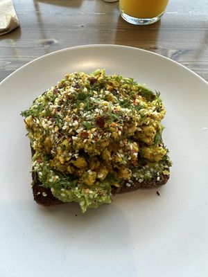 AVOCADO TOAST
AVOCADO. CHILI FLAKES. TOASTED SESAME SEEDS. LEMON. NUTRITIONAL YEAST. SOURDOUGH BREAD. (I had them substitute the fried egg with scrambled tofu)    at Harvest on 25th in Waco