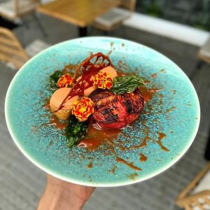Roasted tomato on a tomato jam base, accompanied by rosemary and thyme focaccia with tomato mousse and homemade sun-dried tomato chips, topped with fried basil leaves at MIMO in Malaga