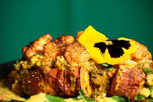 Our all time favorite Papa Mágica:

Roasted sweet potato with chickpea curry, spinach, and tahini, finished with cauliflower, peanuts, and mandarin–poppy seed sauce. at MIMO in Malaga