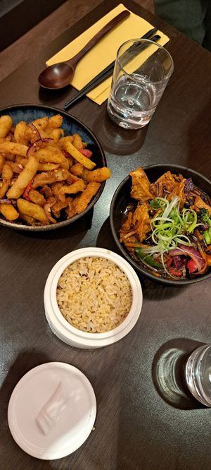 Brown rice & grains, tofu in black bean sauce, salt & chilli chips at Suissi Vegan Kitchen  in Glasgow