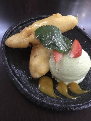 Banana fritters in syrup with avo ice cream & mango coulis at Suissi Vegan Kitchen  in Glasgow