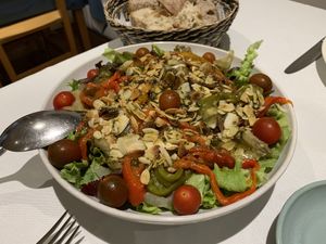 Hearty, delicious green salad with cherry tomatoes, grilled aubergine and paprika, roasted almond splitter and pesto.   at Curcuma in Vigo