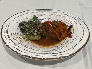 Roast aubergine in a rich sauce  at Curcuma in Vigo