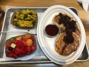 Pancakes with Tofu Scramble and side of mixed fruit. The Sweet Onion Jelly is delicious   at Dharma Southern Kitchen in Tampa