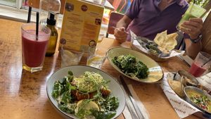 Vegan curry (to the right) and vegetable side dish (in the middle)   at Rooted in Bath