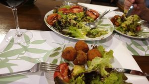Avocado salad and mushroom and sweet potatoes croquettes half eaten at A Porta Verde in Santiago De Compostela