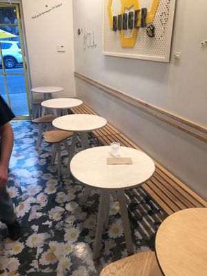 Indoor table seating at Honeybee Burger in Los Angeles