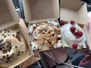 Coffee frosting with chocolate chips, s’mores, and lemon frosting with fresh raspberries   at Cinnaholic in Pearland