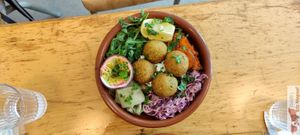Homemade Falafels & White Sauce, Fried Sweet Potatoes, Coleslaw Red Cabbage & Chipotle, Roasted Peppers, Salad, Passion Fruit, Fresh Parsley at Mōpa in Paris