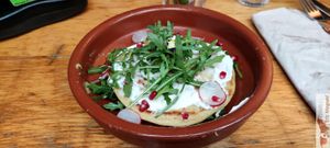 Duo of pancakes, verde hummus, cream cheese, salad, radish, pomegranate, erable balsamic vinaigrette at Mōpa in Paris