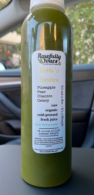Bottle ‘o sunshine juice from the grab and go refrigerator  at Rawfully Yours Juice Bar & Cafe in Lasalle