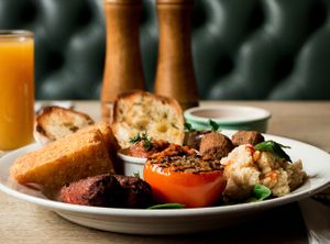 Vegan breakfast with home made beans, vegan chorizo sausages, hash browns, tomato, mushrooms, spinach, felafal & home made hummus with toasted ciabatta  at The Queens Head in Farnham