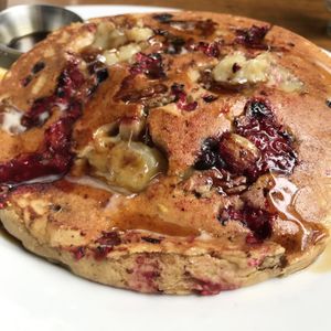 Golden cakes w/ raspberries, blueberries, bananas, pecans  at Follow Your Heart Market & Cafe in Canoga Park