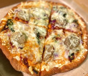 Vegan Marinara pizza w/ veg sausage, red onions, basil.  at Follow Your Heart Market & Cafe in Canoga Park