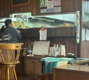 Our food sitting on the counter as wait staff looks on  at Follow Your Heart Market & Cafe in Canoga Park