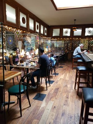 Post Covid. Plexiglass between each table. at Follow Your Heart Market & Cafe in Canoga Park