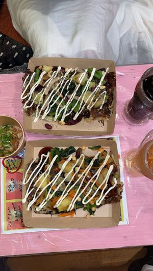 Okonomiyaki with kimchi on the side  at OKO Okonomiyaki in Osaka