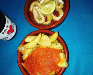 Calamares rebozado y patatas bravas at CactusCat Bar in Barcelona