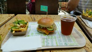 Chicken burger with cheese fries and ice tea peach at Vedang - green burger | Mall of Berlin in Berlin