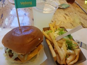 Cheesy burger with cheesy fries amd lemonade at Vedang - green burger | Mall of Berlin in Berlin
