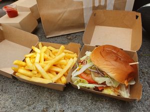 A cheesyburger with bacon and fries. (The burger looks like this because it spent some time in my bag, don't worry 🤭) at Vedang - green burger | Mall of Berlin in Berlin