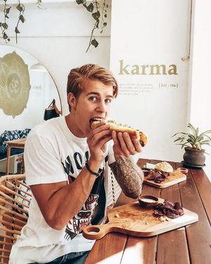 Southwestern Hot Dog 
toasted hotdog bun, mushroom sausage, guacamole, salsa, mustard, purple chips, vegan roasted garlic aioli at Dharma Coffee Canggu in Canggu