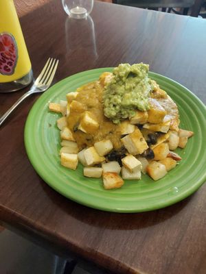 Verde sauce a bit spicier than red. Tofu rancheros with avocado added. Be sure to hold the cheese! at Love Muffin Cafe in Moab