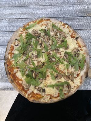My (rather large) small pizza. I chose the funghi and it was topped with lots of fresh rocket, fresh mushrooms and lots of tasty vegan cheese  at Jonny Como Pizza in Playa Del Carmen