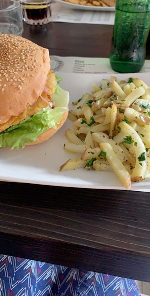 Burger with a chickpea patty and as side the boiled potatos  at QuBe in Jesolo