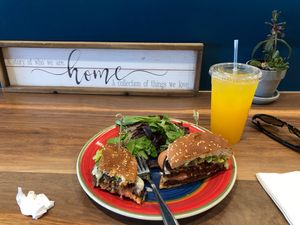 Plant burger plus tempeh bacon and vegan cheese, and turmeric ginger lemonade. Mmm at Protein Plants Cafe in Orange