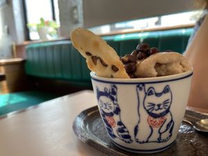 My friend ordered ice cream (vegan) came in a super cute cup with rice cracker!  at Hoccori Cafe in Tokyo