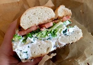 Spinach artichoke tofu spread with broccoli, cucumber, & tomato on an everything bagel.  I love all the veggies. at New York City Bagel & Coffee House in Astoria