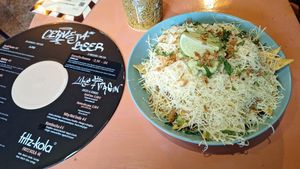 Green and gold nachos and drinks menu at Vegan Junkies in Lisbon