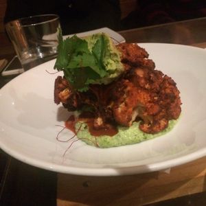 Baked Tandoori Cauliflower w/ avo & tahini cream at Yulli's in Surry Hills