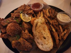 Big Creole Basket With Fried Oyster Mushrooms, Fried Shrimp, Enoki Mushroom, Boudin Ball, Garlic Toast & Fries (soy, Oyster Mushroom) at Vegan Food House in Dallas