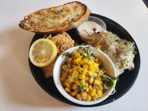 Fried "fish" oysters, corn, mashed potatoes, and garlic bread at Vegan Food House in Dallas