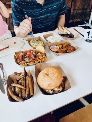 Shrimp Creole Nachos middle left; Chick’em Sammich bottom right; Buffalo wings middle right at Vegan Food House in Dallas
