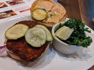 Real Nashville hot combo, chickn, hot sauce, slaw, pickle chips with side of steamed kale at Native Foods in Palm Springs