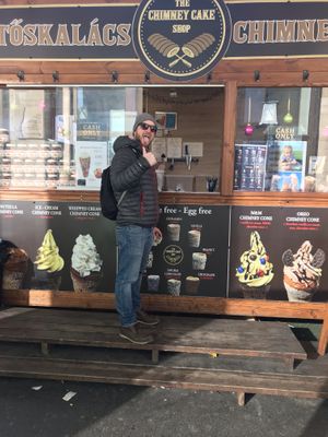 Happy chimney cake eater  at Kurtoskalacs The Chimney Cake Shop in Budapest