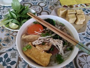Center and left: the phở and its complimentary herbs. Right: extra fried tofu at Loving Vegan in Da Nang