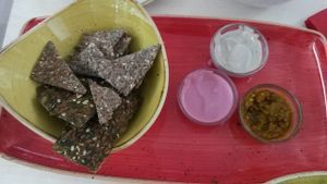Mezze plate (part of the lunch menu) incl. 2 kinds or raw seed crackers and three dips (today: hose radish, sunflower seed butter and spicy zhuk made with 15 different veggies at Adoravita in Zug