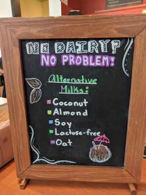 Advertising for (mostly) non-dairy milks! Oat milk is new as of May 2019 :) at Good Earth Coffeehouse - Taylor Family Digital Library in Calgary