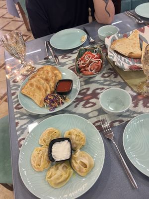 Vegan manti (yoghurt on the side), salad, bread and gumma with potato (all vegan)  at Mirza Boshi in Khiva
