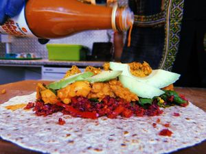 Raja Wrap. 
Rainbow Salad, refried Daily Dhal, Bhajia Falafel, Avocado & Vegan Mayo.
Wrapped, Packed & Toasted. at En Root in South West London