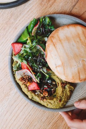 Homemade Hummus with Pumpkin Seed Oil, Seasonal Fruits and Pita  at Reggeli in Pecs
