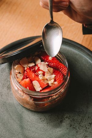Homemade cold porridge made from gluten free oat, redcurrant juice and plum jam, with seasonal fruits. Vegan at Reggeli in Pecs
