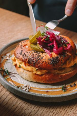 Breakfast Bagel. Homemade bagel, scrambled eggs, pickled veggies. For vegetarian option ask for roasted mushrooms instead of bacon:) at Reggeli in Pecs