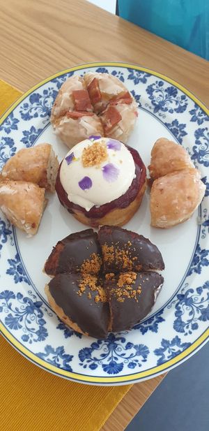 A variety of donuts: Panna cotta and blueberry (middle), classic (sides), Belgian chocolate (bottom), maple and bacon (top). All delicious at Scoop 'n Dough in Lisbon