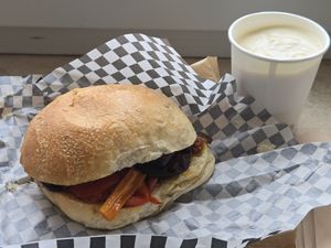 Vegan sandwich and yogurt with fresh fruit underneath at Rosemary in Rome